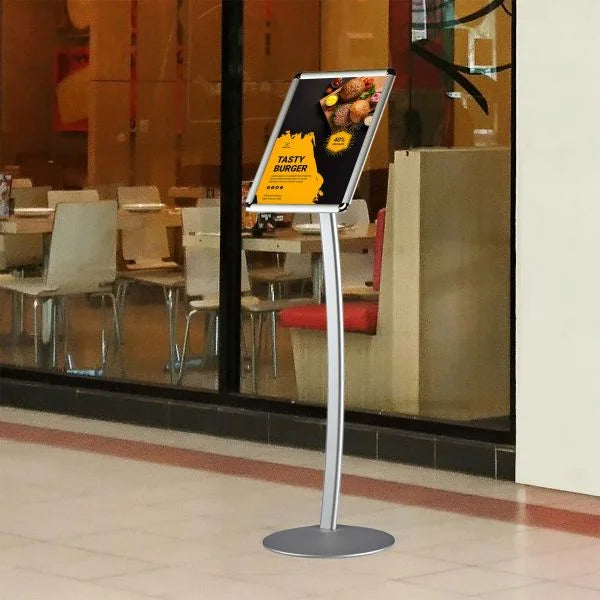 Porte affiche aluminium sur pied avec cadre clic-clac installé devant un restaurant